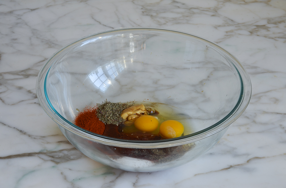 assaisonnement et œufs dans un bol à mélanger pour pain de viande de dinde